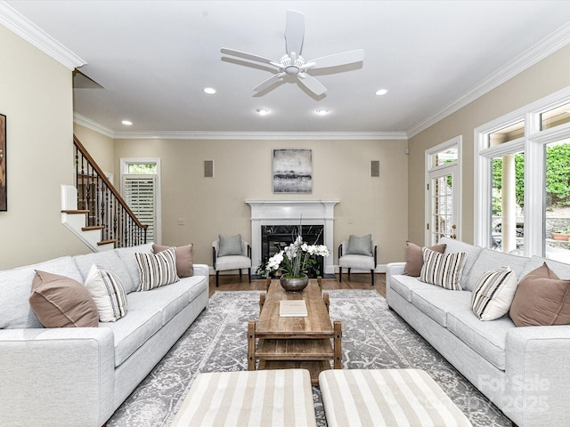living area featuring wood finished floors, recessed lighting, a wealth of natural light, and a high end fireplace
