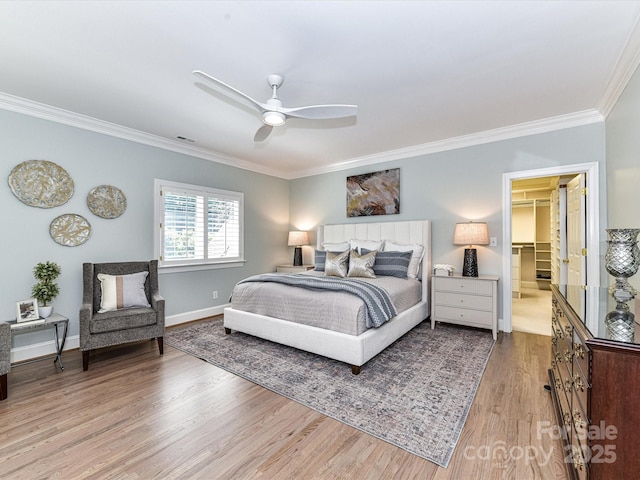 bedroom with crown molding, baseboards, a ceiling fan, and light wood-type flooring