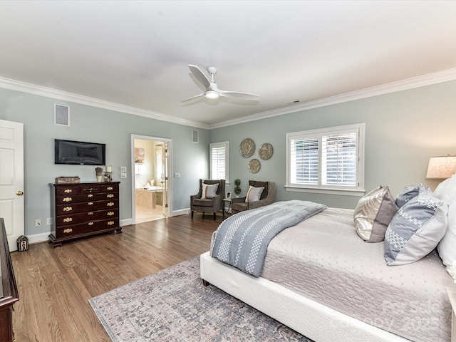 bedroom featuring baseboards, ornamental molding, wood finished floors, and visible vents