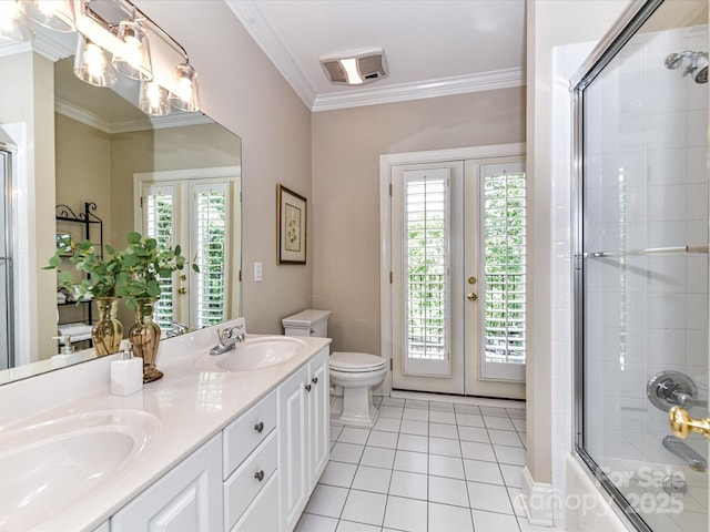 bathroom featuring french doors, a sink, and tile patterned floors