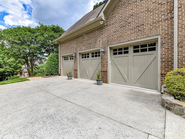 garage featuring concrete driveway