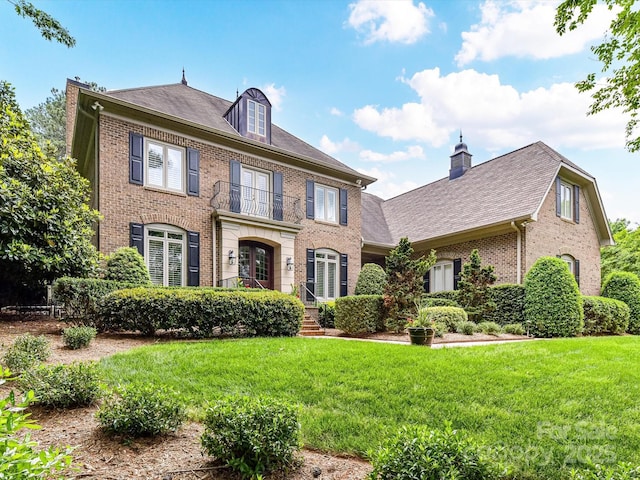 14650 Trading Path Way, Charlotte, NC 28277 - colonial-style house with brick siding, a front yard, a chimney, and roof with shingles