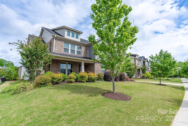 16711 Monocacy Blvd, Huntersville, NC 28078 - view of front facade with a standing seam roof, a front yard, and brick siding