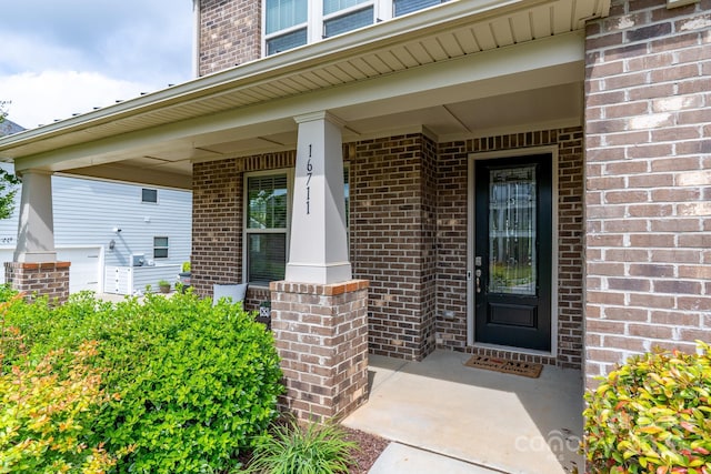 16711 Monocacy Blvd, Huntersville, NC 28078 - doorway to property featuring covered porch and brick siding
