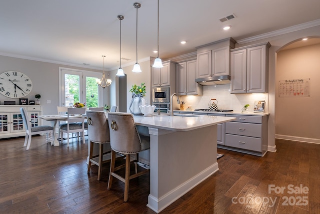 16711 Monocacy Blvd, Huntersville, NC 28078 - kitchen with gray cabinets, arched walkways, appliances with stainless steel finishes, light countertops, and a sink