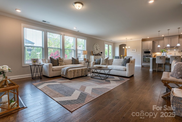 16711 Monocacy Blvd, Huntersville, NC 28078 - living room with crown molding, an inviting chandelier, visible vents, and baseboards