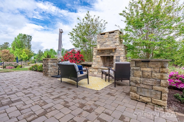 16711 Monocacy Blvd, Huntersville, NC 28078 - view of patio with fence and an outdoor stone fireplace