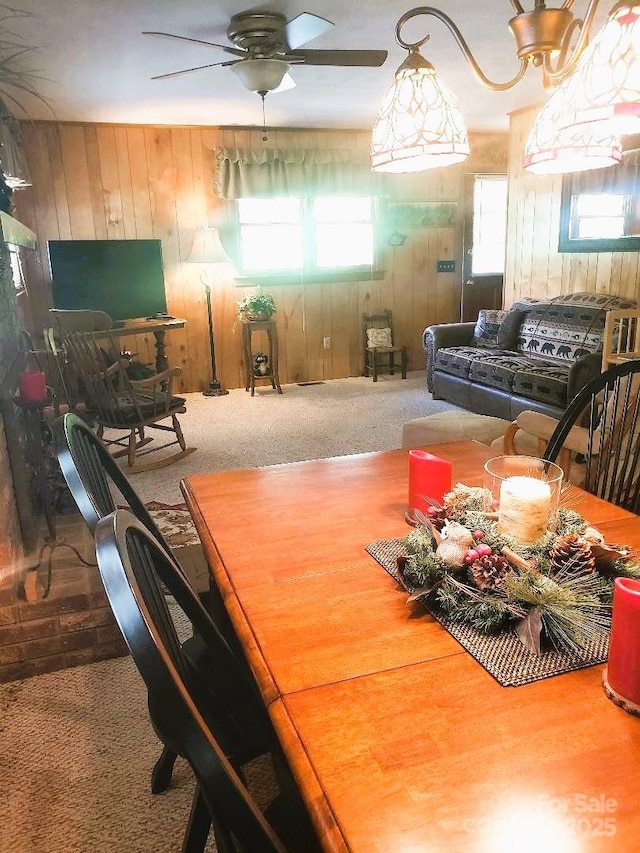 134 Raven Rdg, Maggie Valley, NC 28751 - carpeted dining area with wooden walls and a ceiling fan