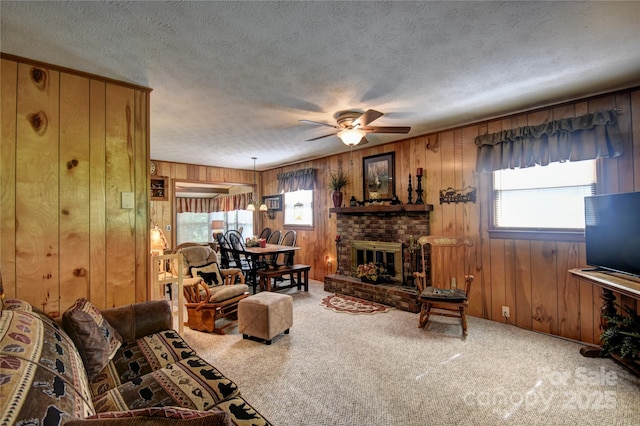 134 Raven Rdg, Maggie Valley, NC 28751 - living area with ceiling fan, plenty of natural light, wooden walls, a textured ceiling, and carpet floors