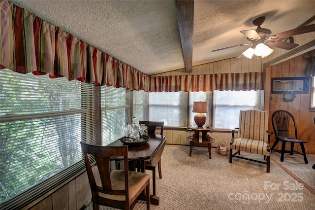 134 Raven Rdg, Maggie Valley, NC 28751 - carpeted dining area with a textured ceiling, wooden walls, and a ceiling fan