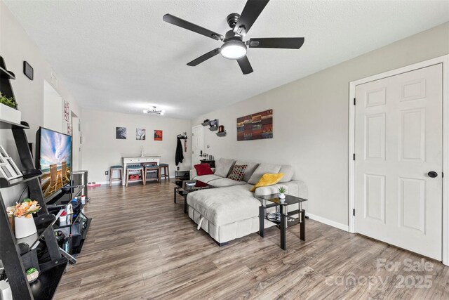123 Carriage House Dr, Kannapolis, NC 28081 - living area featuring ceiling fan, wood finished floors, a textured ceiling, and baseboards