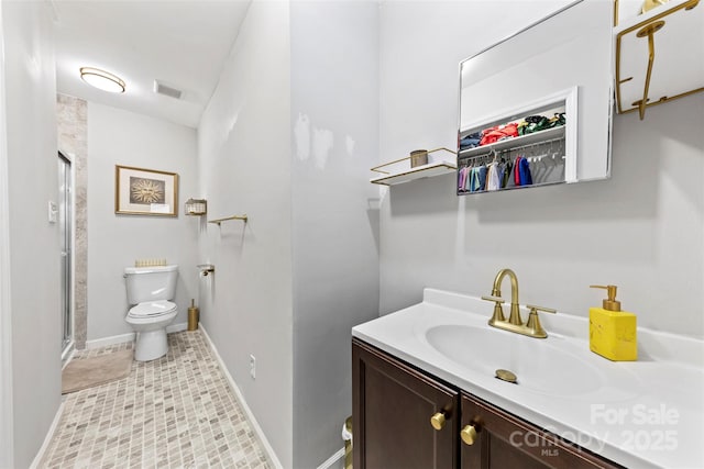 123 Carriage House Dr, Kannapolis, NC 28081 - full bathroom with vanity, toilet, a stall shower, baseboards, and a spacious closet