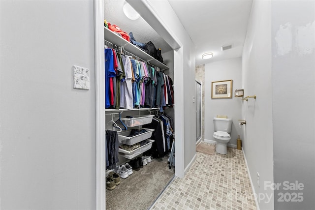 123 Carriage House Dr, Kannapolis, NC 28081 - full bathroom with a stall shower, a spacious closet, toilet, and tile patterned floors