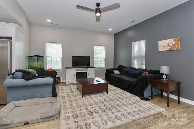 living room with a ceiling fan, light wood-style flooring, healthy amount of natural light, and recessed lighting