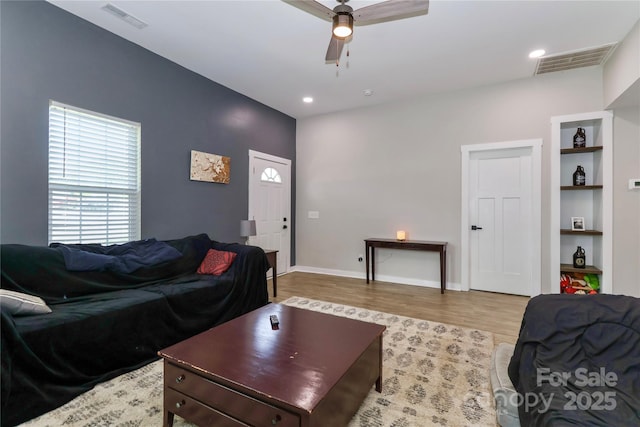 living room featuring ceiling fan, wood finished floors, baseboards, and recessed lighting