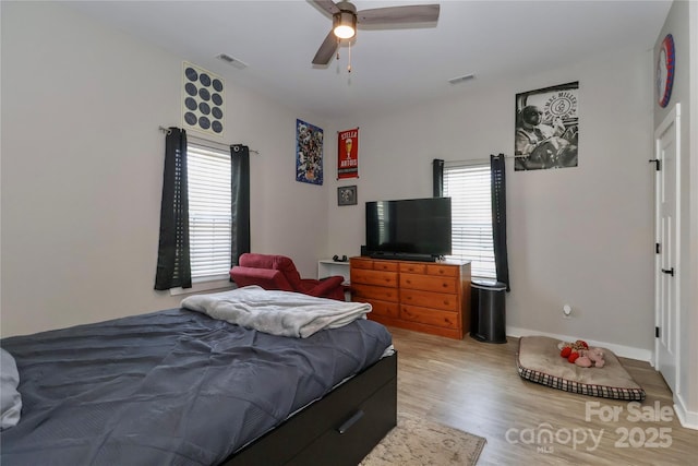 bedroom with wood finished floors, baseboards, and a ceiling fan