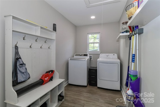 laundry area with washer and clothes dryer, attic access, wood finished floors, recessed lighting, and baseboards