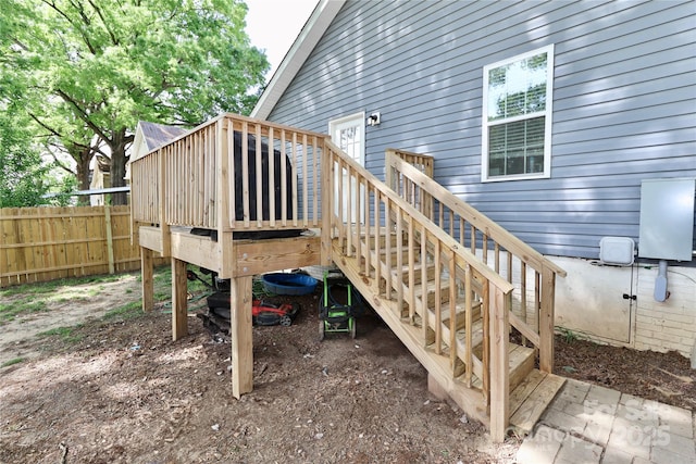 wooden terrace featuring fence