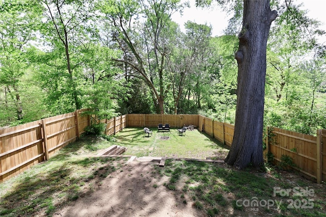 fenced backyard with an outdoor fire pit