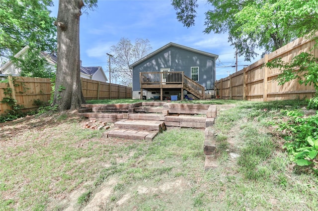 back of house featuring a wooden deck, stairs, and a fenced backyard