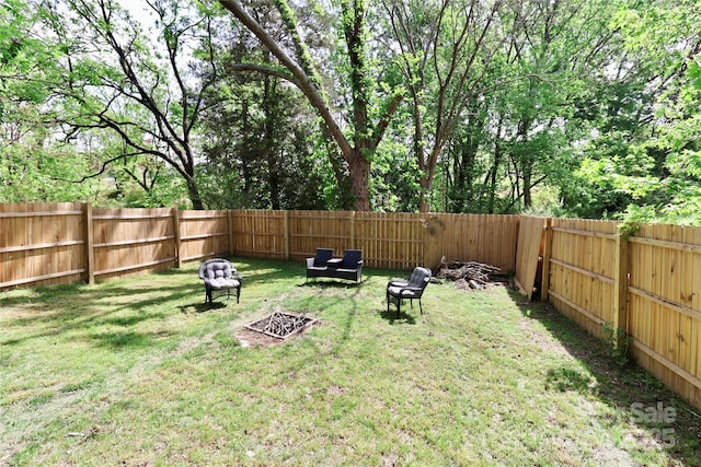 view of yard with a fire pit