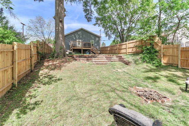 view of yard featuring a deck and stairs