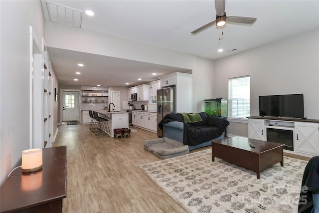 703 S Main St, Landis, NC 28088 - living room with light wood-type flooring, a ceiling fan, and recessed lighting