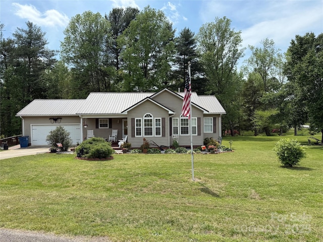 single story home featuring driveway, a front yard, metal roof, and a garage