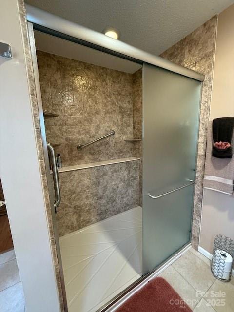 bathroom featuring tile patterned flooring and a stall shower