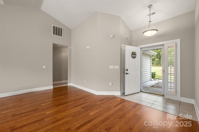 2412 Laura Dr, Charlotte, NC 28212 - entrance foyer featuring visible vents, baseboards, wood finished floors, and high vaulted ceiling