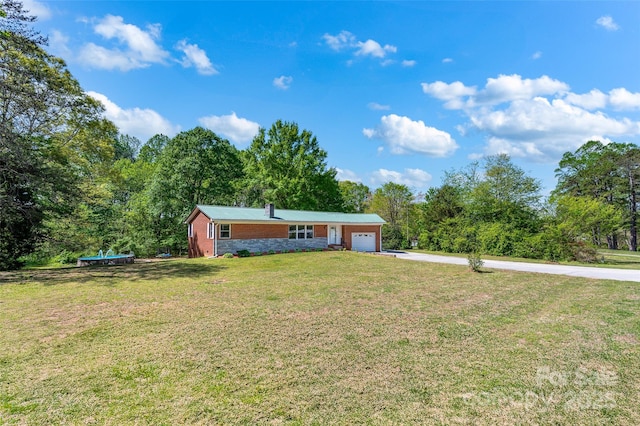ranch-style house with an attached garage, a front yard, and concrete driveway