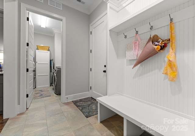 mudroom featuring visible vents and washing machine and clothes dryer