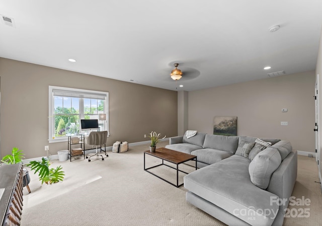 carpeted living area with baseboards, visible vents, and ceiling fan