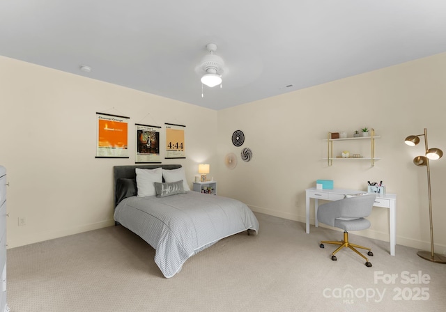 carpeted bedroom with ceiling fan and baseboards