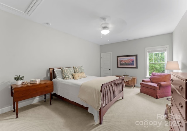 bedroom with ceiling fan, light carpet, and baseboards