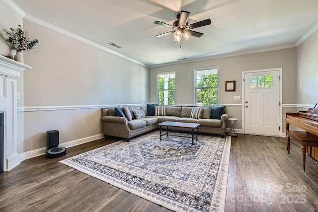 living room with visible vents, crown molding, ceiling fan, and wood finished floors
