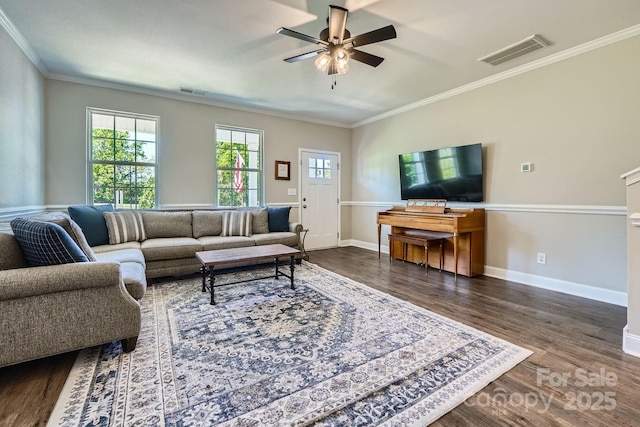 living room featuring crown molding, a ceiling fan, dark wood-type flooring, and visible vents