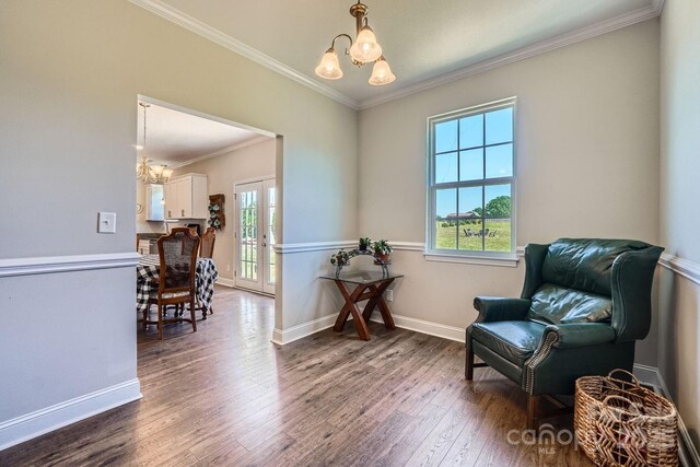 living area with an inviting chandelier, a healthy amount of sunlight, and hardwood / wood-style floors