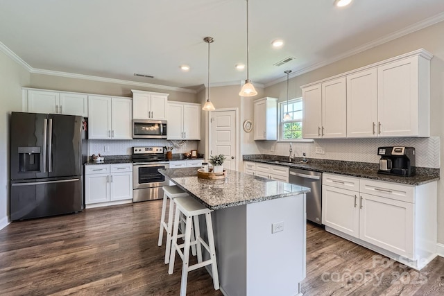 kitchen featuring a sink, appliances with stainless steel finishes, white cabinetry, and visible vents