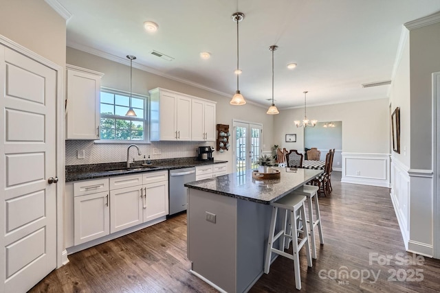 kitchen featuring a sink, plenty of natural light, french doors, and dishwasher