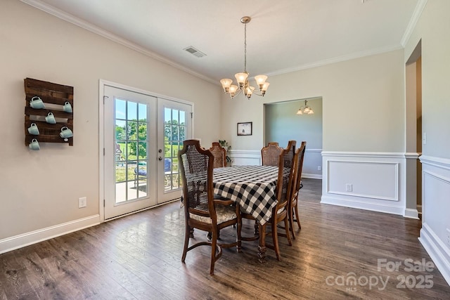 dining area with visible vents, ornamental molding, a chandelier, and french doors