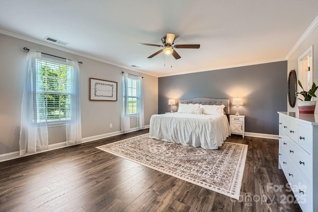 bedroom with ceiling fan, visible vents, baseboards, dark wood-style floors, and ornamental molding