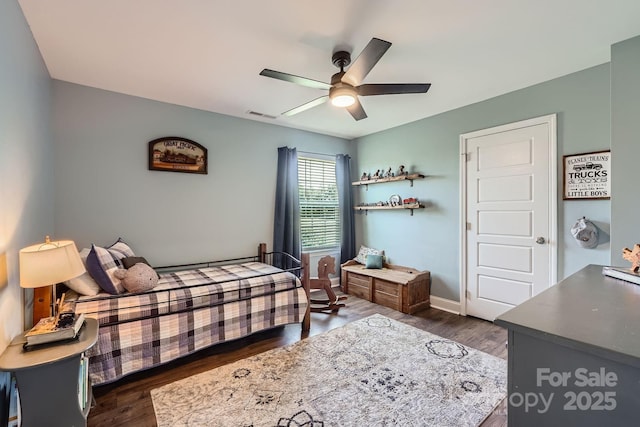 bedroom with baseboards, a ceiling fan, dark wood-style flooring, and visible vents