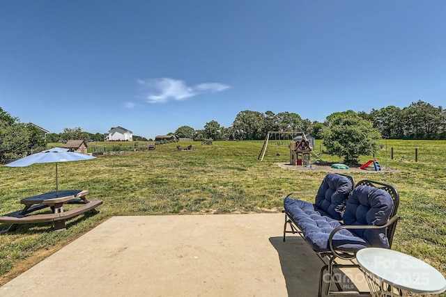 view of patio with a playground and an outdoor hangout area