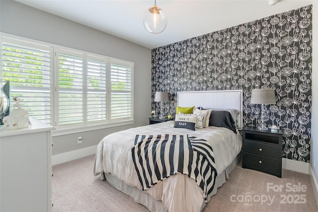 carpeted bedroom with baseboards, wallpapered walls, and an accent wall