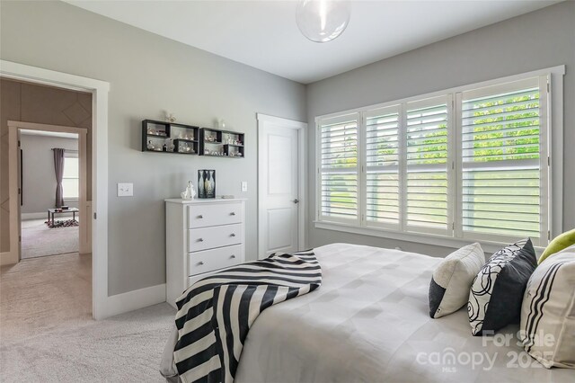 carpeted bedroom featuring baseboards