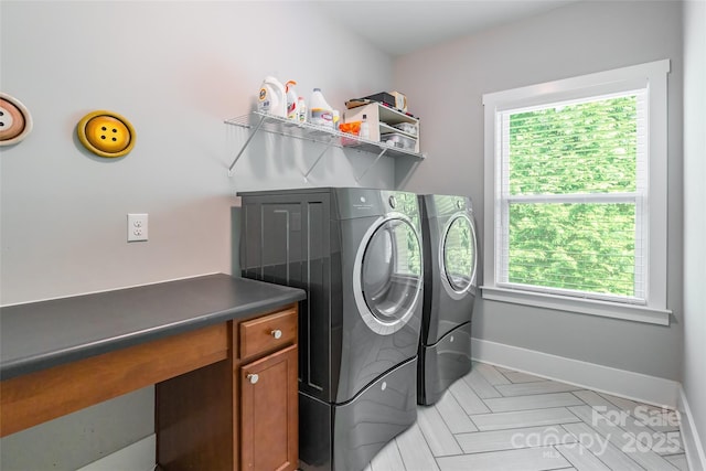 laundry area with washer and dryer, laundry area, and baseboards