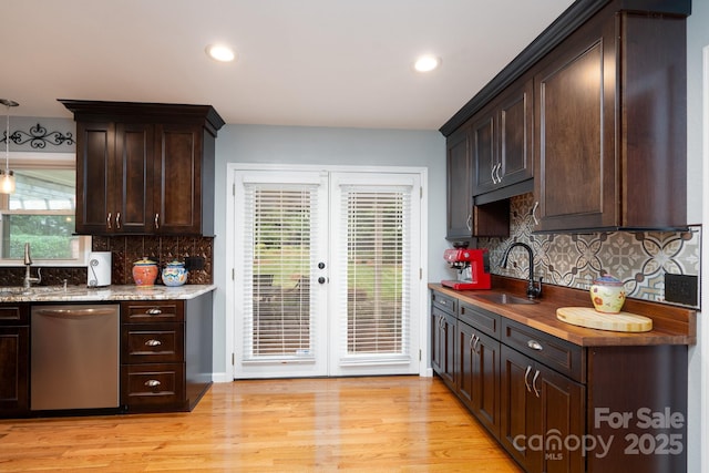 kitchen with dishwasher, a sink, dark brown cabinetry, and recessed lighting