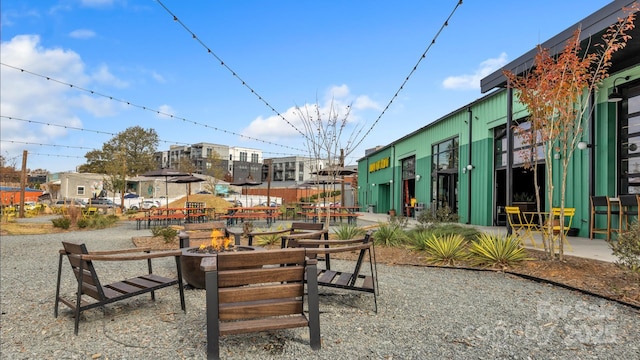 view of property's community featuring a fire pit