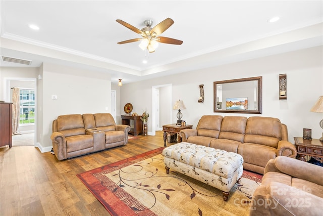 living room with visible vents, recessed lighting, wood finished floors, ceiling fan, and a raised ceiling